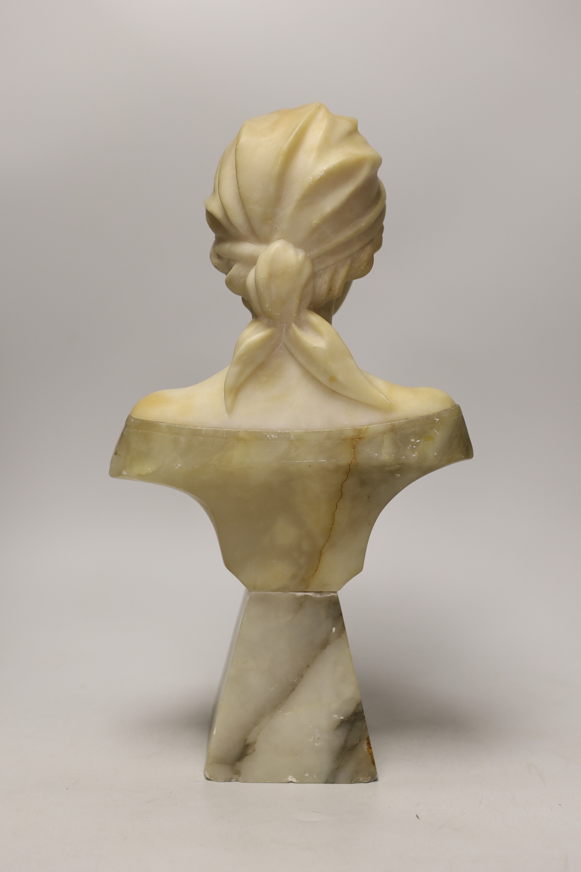 An early 20th century alabaster and marble bust, signed. 37cm tall